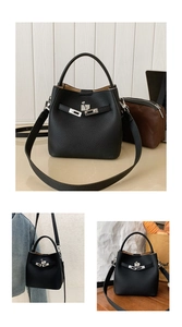 Close-up of black lychee grain leather bucket bag with metallic twist lock and strap