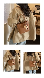 Close-up of brown litchi pattern bucket bag with cute bear charm and bow decoration