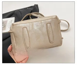 Close-up of beige bucket bag base with reinforced stitching and textured leather finish
