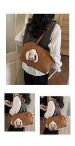 Detail view of vintage caramel tote bag featuring a cute white plush bunny charm