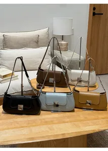Five elegant baguette bags in various colors displayed on a modern metal stand