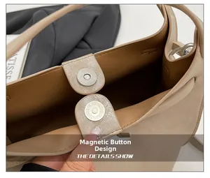 Macro view of magnetic snap closure and textured interior of beige bucket bag