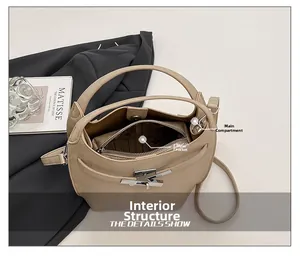Detail view of the beige bucket bag internal structure with main pocket and zipper pocket