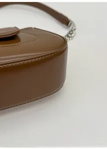 Close-up of the widened sturdy bottom and premium stitching on the brown leather bag