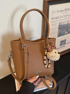 Deep brown lychee grain leather bucket bag with cute bear charm and colorful bead chain