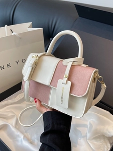 Chic two-tone cream and pink leather handbag with top handle and adjustable strap
