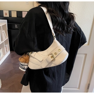 Chic off-white baguette bag with metallic buckle and cute brown bear charm detail