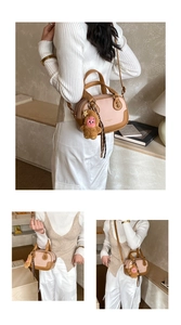 Detail view of pink and brown leather crossbody bag with plush charm and silk scarf decoration