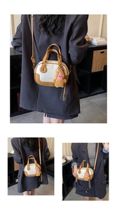 Detail of retro color-block bowling bag with brown plush charm and crossbody strap