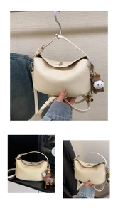 Macro shot of cream-colored pebble leather bag texture with silver metallic twist lock closure