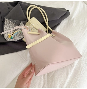 Detail of pink PU leather tote with colorful beads and Love Is Eternal ribbon