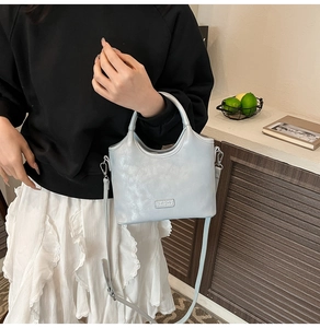 Détail du similicuir bleu clair texturé et de la bandoulière réglable de ce sac à main chic