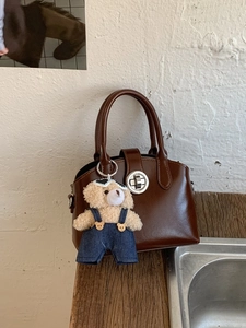 Vintage dark brown leather handbag with silver twist lock and cute plush bear charm