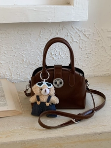 Vintage brown crossbody handbag with silver lock and a cute plush bear pendant