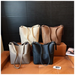 Selection of four bucket bags in cream, brown, taupe and black pebbled leather texture