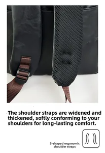 Close-up of S-shaped ergonomic breathable mesh shoulder straps on black leather backpack