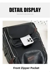 Close-up of front zipper pocket on black PU leather backpack with inserted smartphone