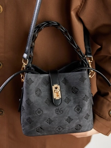 Retro black embossed bucket bag with intricate floral embroidery and woven top handle