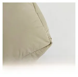 Detailed macro shot of high-quality textile fabric and stitching on a beige tote bag