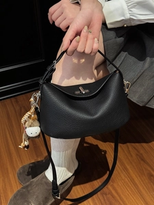 Chic black litchi pattern underarm bag with metal lock and horse charm decoration