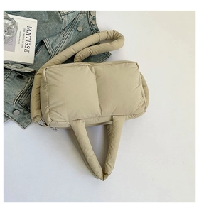 Top view of beige quilted puffer tote bag with durable nylon material and metal zipper