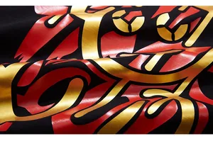 Macro shot of gold and red premium graphic print on high-quality black cotton fabric