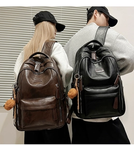 Detailed view of large capacity faux leather backpacks in dark brown and black colors