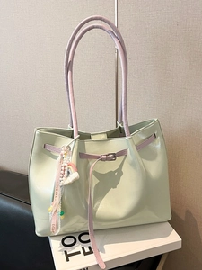 Mint green large capacity tote bag with lavender straps and rainbow charm accessory