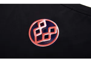 Detailed macro view of high-quality red circular graphic print on black cotton t-shirt fabric