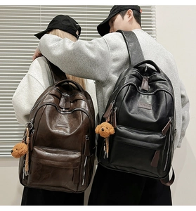 Lifestyle shot of large PU leather backpacks in black and brown with plush charms