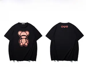 Front and back view of black oversized T-shirt with orange bear graphic and typography