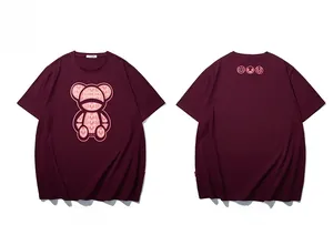 Flat lay of maroon oversized cotton t-shirt with teddy bear and monogram print details