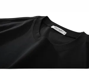 Detail view of the ribbed crew neck and 450g 4XL size label on the black cotton T-shirt
