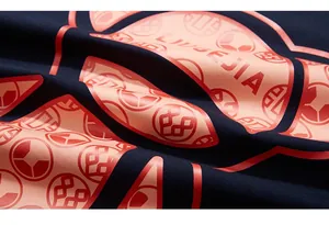 Macro detail of navy blue t-shirt featuring orange LUGEJIA screen printed graphics