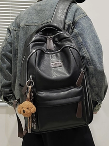 Versatile black PU leather backpack with multi-zipper compartments and teddy bear charm