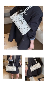 Détail du sac rétro à pois blancs avec fermoir en métal argenté et nœud décoratif chic