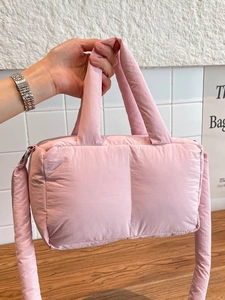 Pink quilted puffer tote bag with soft padding and silver hardware for women