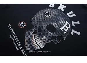 Close-up of halftone skull print and street style lettering on black cotton t-shirt