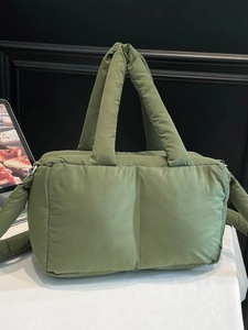 Quilted olive green puffer tote bag with a soft padded handle and spacious interior design