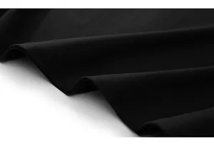 Detail of premium black knit fabric showing high-quality double-needle hem stitching