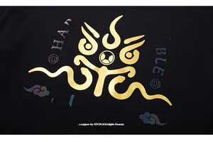 Close-up of golden metallic totem and laser colorful letter print on black cotton T-shirt