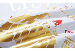 Detail of golden foil polar bear and letter print on white cotton oversized T-shirt