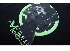 Detail of neon green cyberpunk print on black heavy cotton streetwear T-shirt