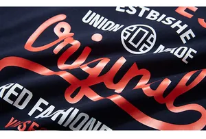 Detail of high-quality navy cotton fabric with thick orange and white letter printing