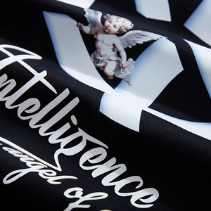 Oversized black cotton T-shirt featuring an angel graphic and geometric cross print