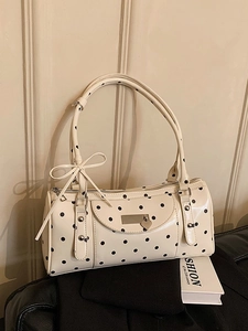 French vintage cylinder handbag with classic black polka dots and a bow detail