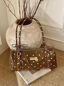 French vintage brown polka dot cylinder handbag with bow and heart buckle detail
