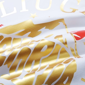 White cotton t-shirt featuring golden polar bear print and metallic letter graphics