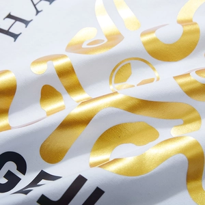 White oversized cotton t-shirt featuring luxury gold foil and colorful letter print detail