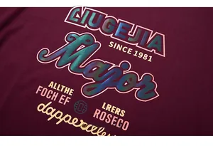 Macro view of reflective iridescent print on burgundy oversized streetwear t-shirt fabric